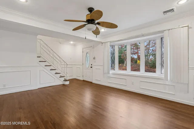 a view of an entryway with wooden floor