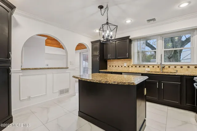 a kitchen with a counter space a sink appliances and cabinets