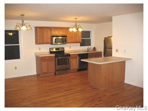 74 North Main Street, Unit 202 Florida, NY 10921 - Photo 2 of 10 a kitchen with stainless steel appliances granite countertop a sink and a stove