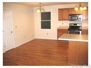 74 North Main Street, Unit 202 Florida, NY 10921 - Photo 4 of 10 a view of a kitchen with microwave and cabinets