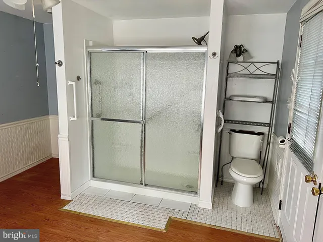 an empty room with a ceiling fan and carpet