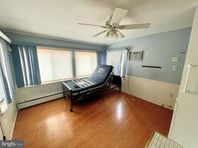 a view of a livingroom with a ceiling fan and window