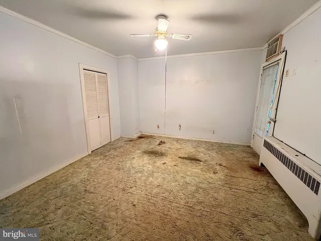 a view of empty room with furniture and window