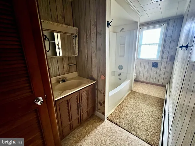a living room with a flat screen tv and washer
