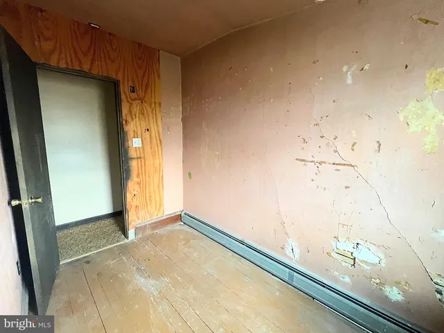 a room with kitchen island a sink a stove and a refrigerator