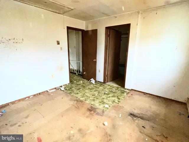 a view of a street with wooden fence