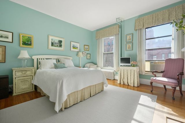 a bedroom with a bed a table and chair