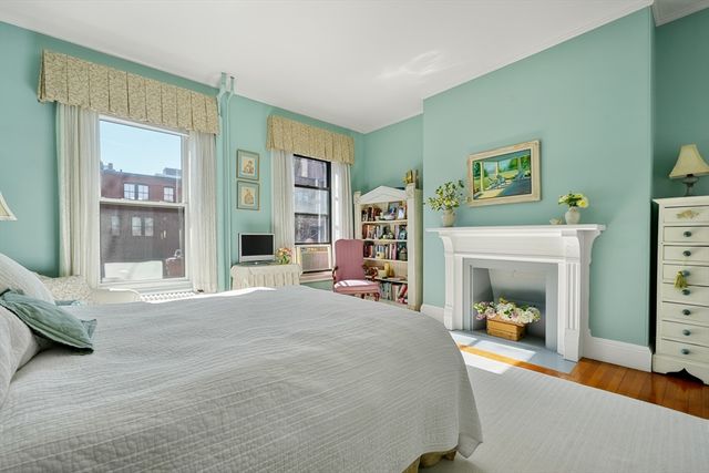 a bedroom with a bed and a fireplace