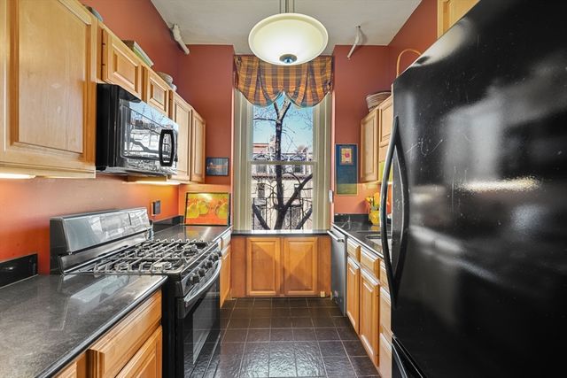 a kitchen with stainless steel appliances granite countertop a stove and a refrigerator