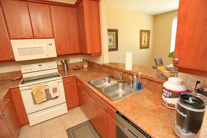 4159 Main Street Jupiter, FL 33458 - Photo 12 of 39 a kitchen with a sink stove and cabinets