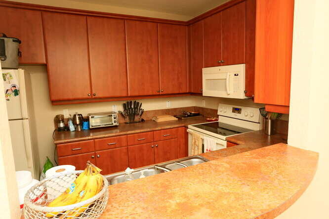 4159 Main Street Jupiter, FL 33458 - Photo 13 of 39 a kitchen with a sink a stove and cabinets