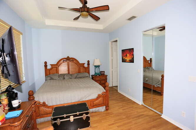 4159 Main Street Jupiter, FL 33458 - Photo 18 of 39 a room with a bed and wooden floor