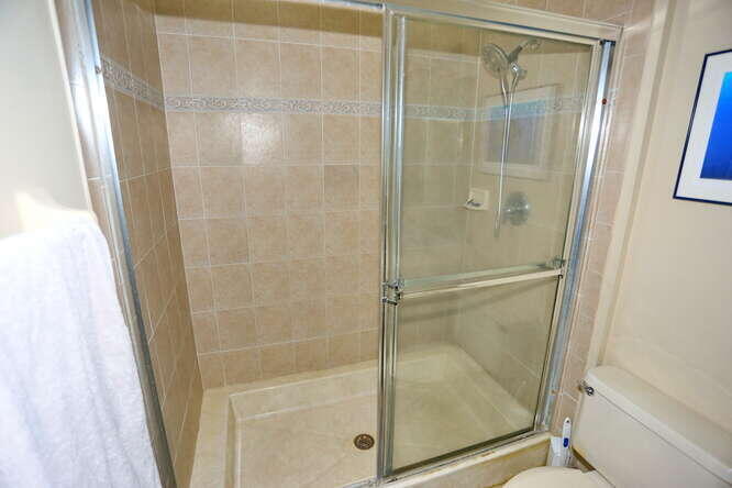 4159 Main Street Jupiter, FL 33458 - Photo 20 of 39 a bathroom with a glass shower door