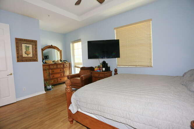 4159 Main Street Jupiter, FL 33458 - Photo 24 of 39 a bedroom with a bed and a television