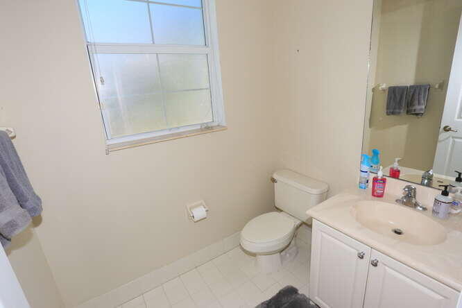 4159 Main Street Jupiter, FL 33458 - Photo 25 of 39 a bathroom with a sink mirror vanity and toilet