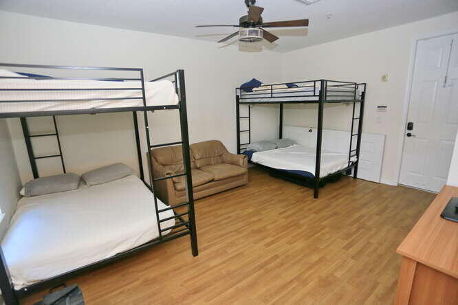 4159 Main Street Jupiter, FL 33458 - Photo 26 of 39 a bedroom with a bed and a chandelier