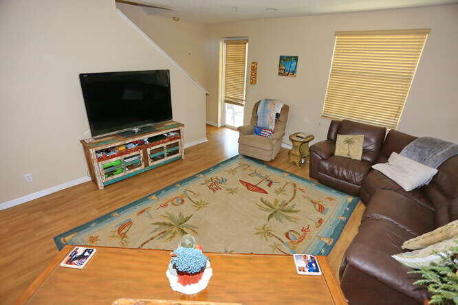 4159 Main Street Jupiter, FL 33458 - Photo 7 of 39 a living room with furniture and a flat screen tv