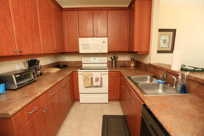 4159 Main Street Jupiter, FL 33458 - Photo 9 of 39 a kitchen with a sink stove top oven and cabinets