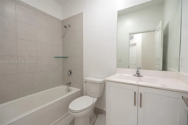 a bathroom with a sink toilet vanity and shower
