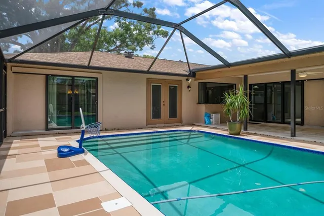 a living room with furniture a table and kitchen view