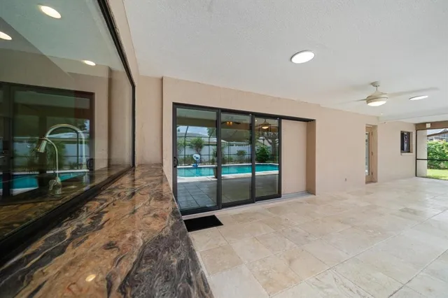 a view of a house with a yard and potted plants