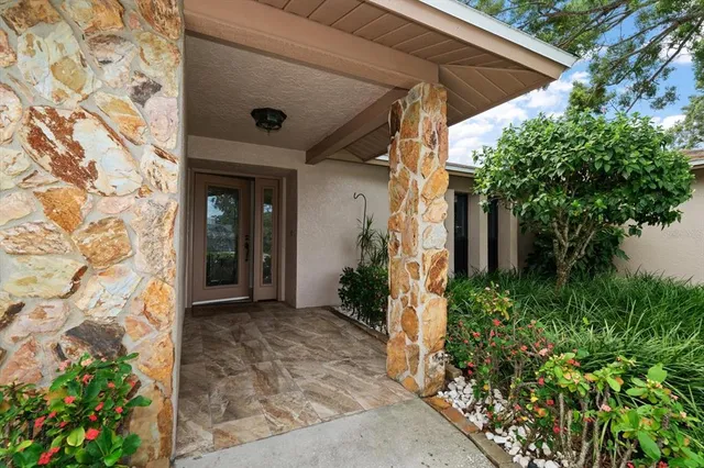 a view of an empty room with a fireplace and a large window