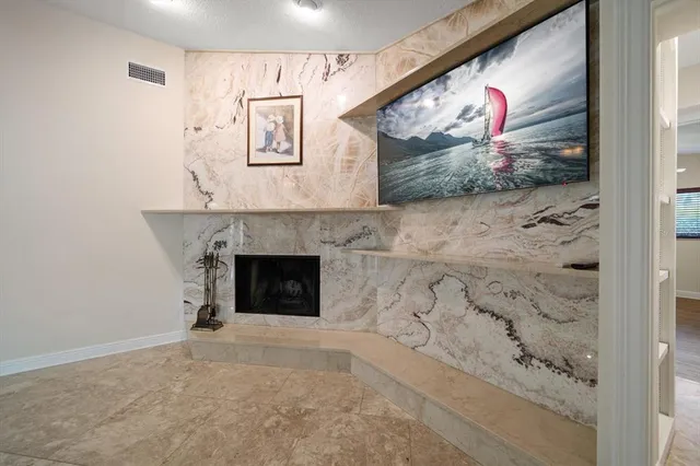 a bathroom with a granite countertop sink two mirror and a vanity