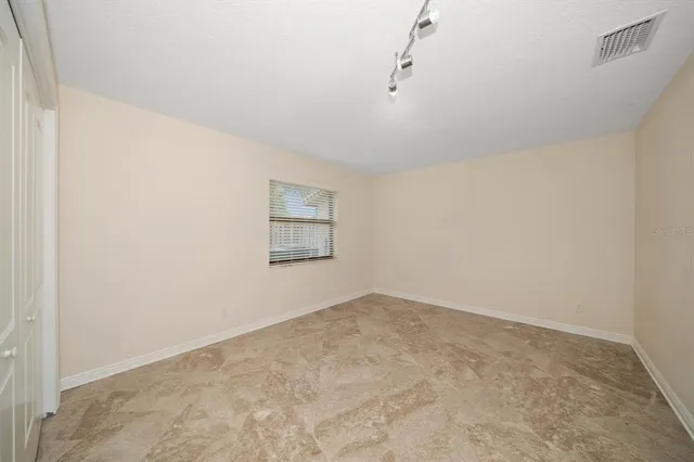 a room with pool table and windows