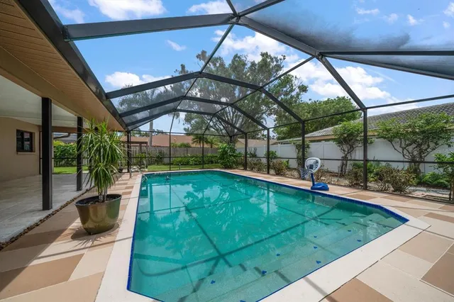 a view of a house with backyard and a garden