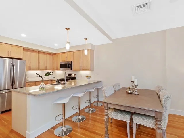 a kitchen with stainless steel appliances a sink stove and refrigerator
