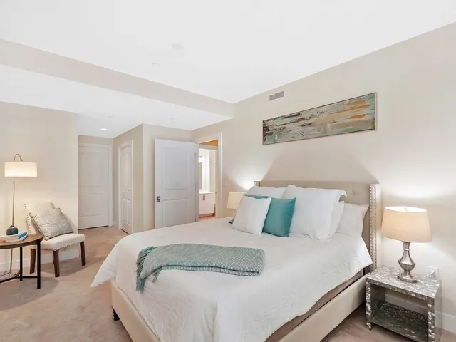 a bedroom with a bed and a lamp