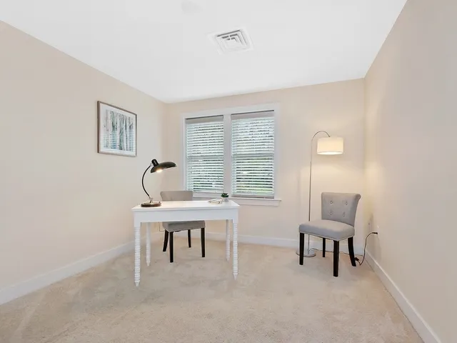 a work room with furniture and a window