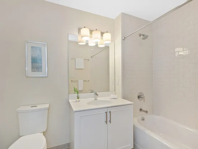 a bathroom with a sink toilet and shower