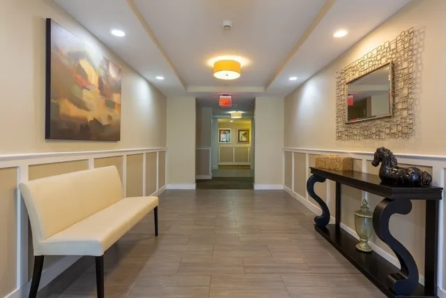 a view of a hallway with seating area