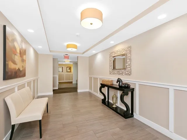 a view of a hallway with seating area