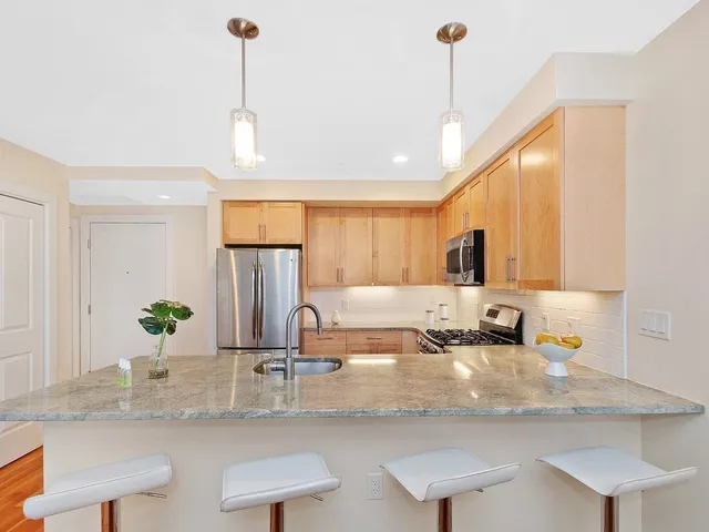 a kitchen with kitchen island granite countertop a sink and window