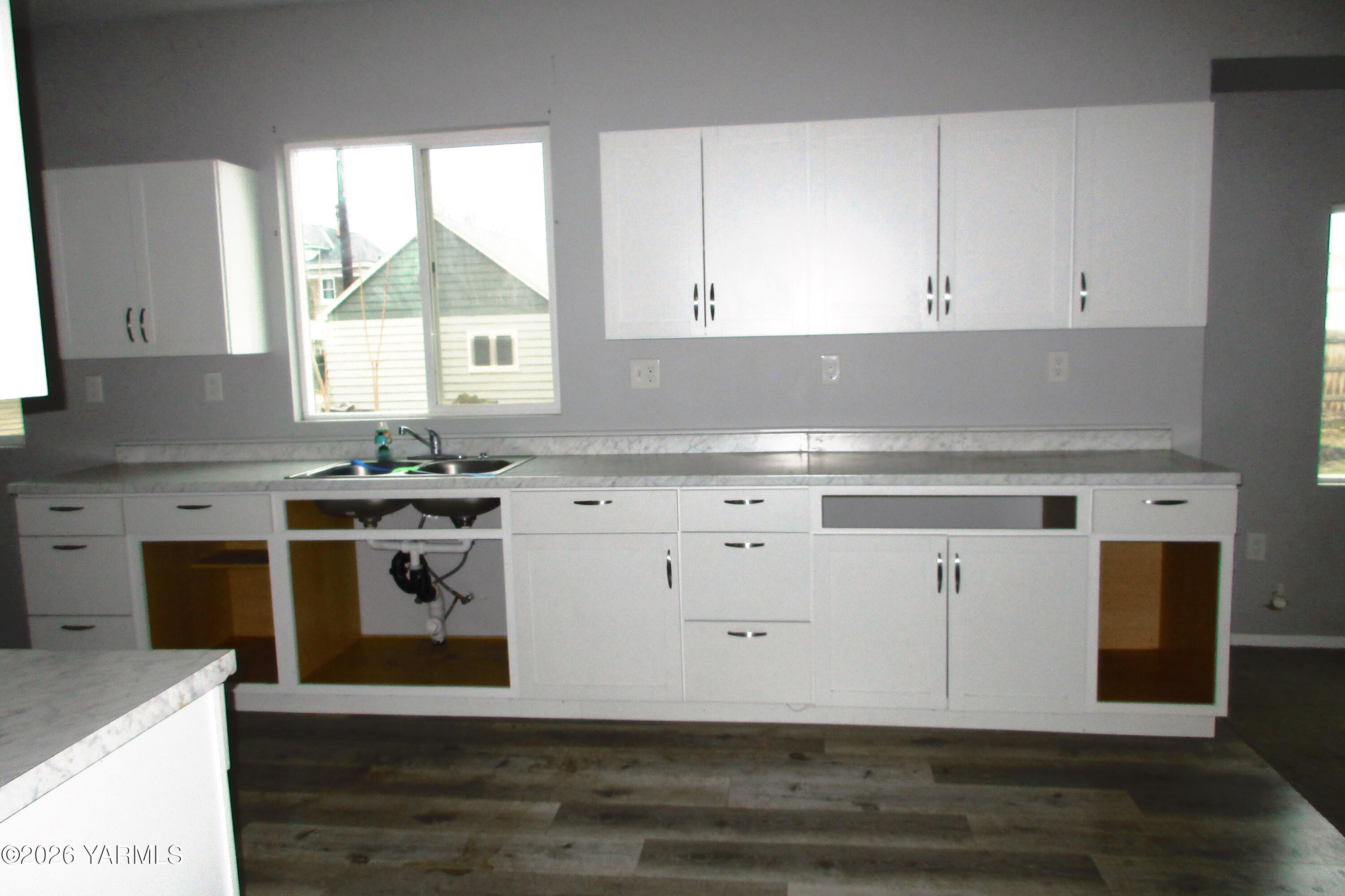 208 North Alder Street Toppenish, WA 98948 - Photo 7 of 14 a kitchen with stainless steel appliances a stove top oven and white cabinets