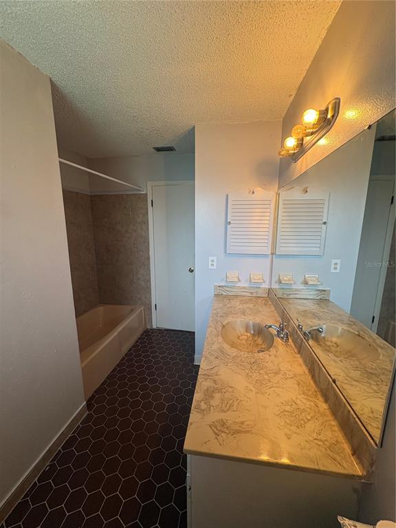4027 Bianca Street Sebring, FL 33872 - Photo 8 of 22 a bathroom with a tub and shower