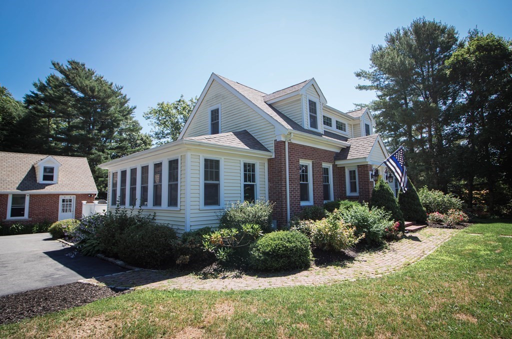 a front view of house with yard and green space
