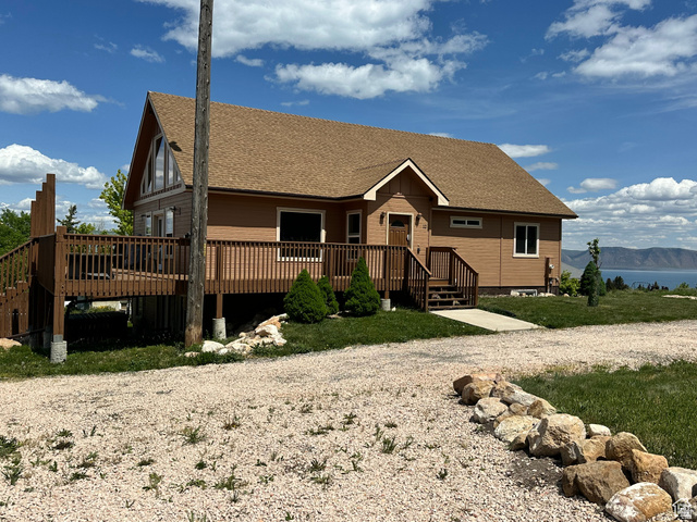 12 Crook Street Fish Haven, ID 83287 - Photo 4 of 35 View of front of home with a shingled roof and a deck with mountain view