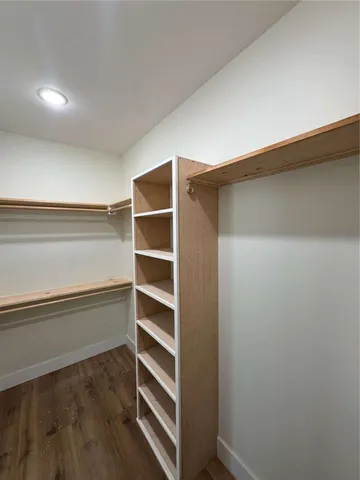 a view of walk in closet with empty racks