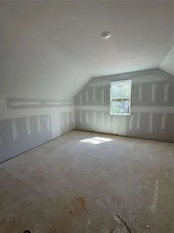 an empty room with a empty space and windows