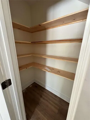 a view of walk in closet with empty racks