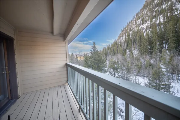 a view of a balcony with wooden floor