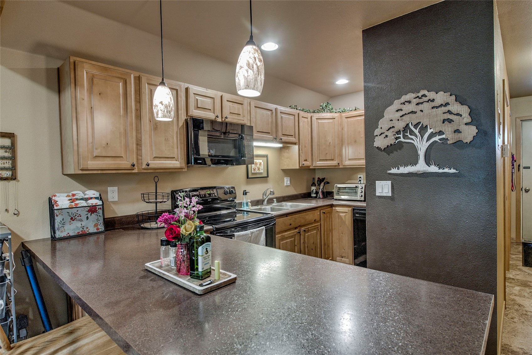 400 West Main Street, Unit 306 Frisco, CO 80443 - Photo 4 of 25 a kitchen with kitchen island granite countertop a sink cabinets and stainless steel appliances