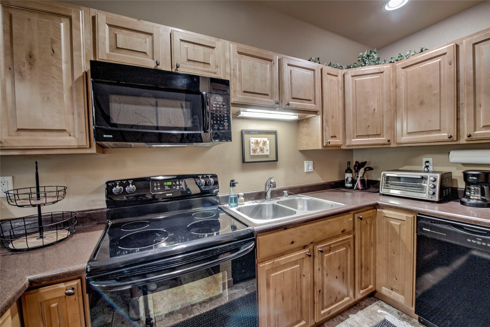 400 West Main Street, Unit 306 Frisco, CO 80443 - Photo 5 of 25 a kitchen with stainless steel appliances granite countertop a stove microwave and sink