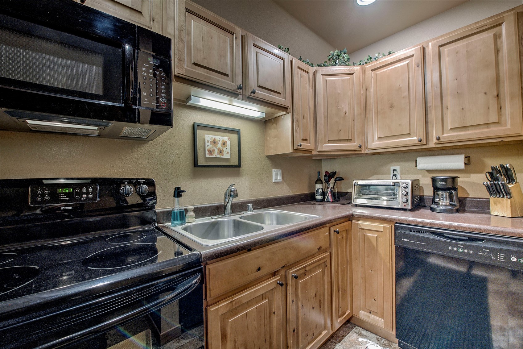 400 West Main Street, Unit 306 Frisco, CO 80443 - Photo 6 of 25 a kitchen with stainless steel appliances granite countertop a stove microwave and sink