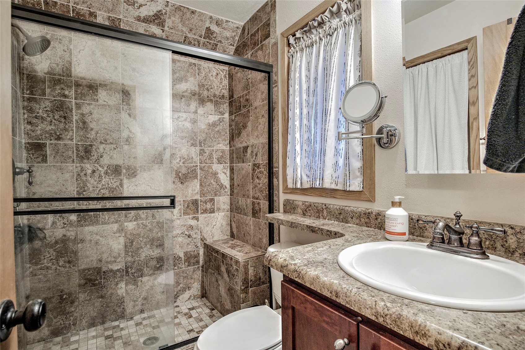 400 West Main Street, Unit 306 Frisco, CO 80443 - Photo 7 of 25 a bathroom with a granite countertop sink a toilet and a mirror