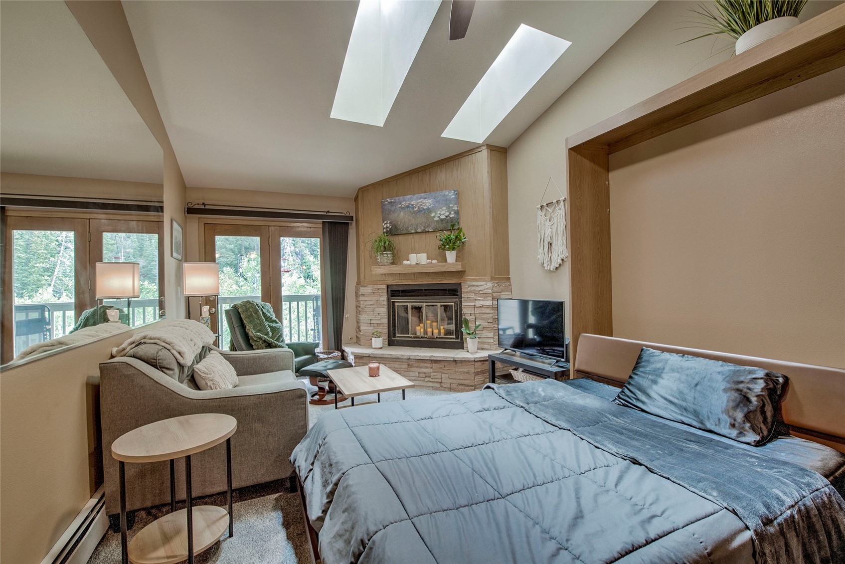 400 West Main Street, Unit 306 Frisco, CO 80443 - Photo 9 of 25 a bedroom with furniture large window and fireplace