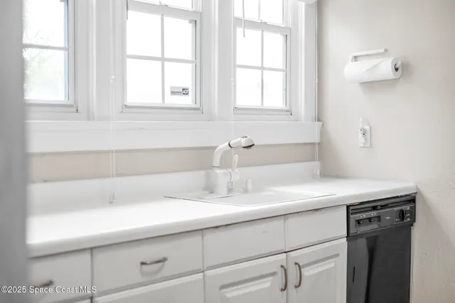 a bathroom with a sink a mirror and a window